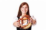 Young woman with Bavarian dirndl holding Oktoberfest pretzel. Isolated on white background.