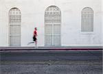 Man jogging down city street for exercise