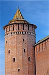 Tower and wall of big castle of red brick and white stone