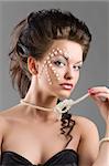 fashion shot of elegant beauty girl with creative make up with pearl necklace looking in camera