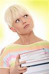 Young caucasian woman (student) with books - looking up