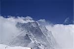 Caucasus Mountains in clouds. Ski resort Dombay.