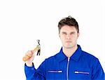 Serious worker holding a hammer looking at the camera against white background