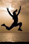 Photo jumping up a young girl at dawn. Morning Red Sea beach.