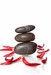 well being concept with stones and red petals on white background