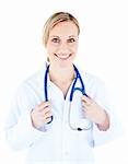 Friendly female doctor holding a stethoscope smiling at the camera against white background