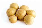 Seven potatoes isolated on a white background.