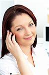 Smiling businesswoman talking on phone sitting in her office