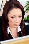 Self-confident businesswoman working at her desk in her office