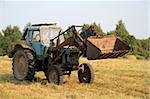 Tractor with a bucket on the farm.