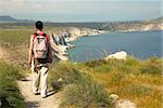 Woman hiking along a cliff