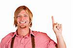 Bavarian man with oktoberfest leather trousers (Lederhose) points with finger at copy space.  Isolated on white background.