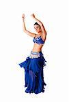 Beautiful Arabic belly dancer harem woman in blue with silver dress and head jewelry with gem dancing swirling skirt, isolated.