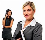 Confident young business woman with co-worker in background