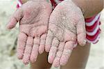 children girl beach sand palm hands facing camera summer metaphor