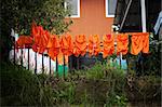 Orange soccer uniforms drying on the line in Costa Rica