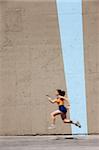 Woman sprinter practices her dash to the finish line.