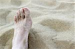 man foot in summer beach sand vacation holydays metaphor