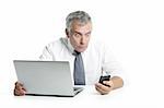 surprised senior businessman expression gesture mobile phone laptop gray hair