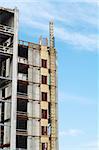 side view of  work in progress highrise building with sky background