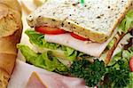 Delicious ham and salad sandwich with ingredients ready to serve.