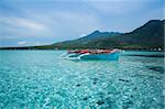 small outrigger traditional fishing boat in the clear seas of camiguin island near mindanao in the philippines