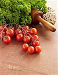 close up of tomato and parsley on wooden table