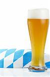 wheat beer with bavarian towel on white background