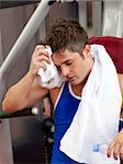 Tired man using a bench press in a fitness center