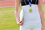 Close-up of a female athlete holding a disc preparing for throwing in a stadium