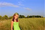 Teenage girl among the high grass. Countryside