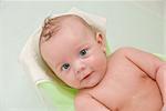 Beauty baby boy having bath at bathing stand