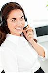 Bright woman wearing a headset working in a customer service