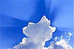 Clouds with rays on a blue sky