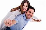 Portrait of young man giving piggyride to her girlfriend against isolated white background