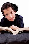 boy lying on a pillow reading