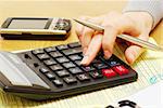 Closeup of a young women calculating bills