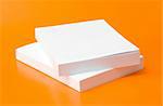 two blank books over an orange background