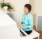 Pianist smiling as she enjoys playing the piano.