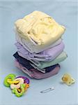 A stack of modern cloth nappies isolated against a blue background