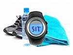 A sports watch isolated against a bottle of water, joggers and a sports towel