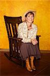 Pretty western woman in antique rocking chair