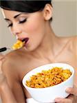 Portrait of beautiful woman eating cornflakes