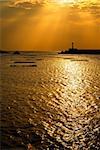 Sunset harbor scenery with silhouette of tower in Taiwan.