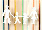 Family figures made from paper with books background, school theme