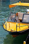 Yellow boat tied up dock