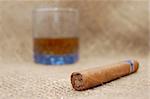 Cuban cigar and glass with wiskey on sackcloth