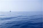 Blue sea with sailboat sailing the ocean surface summer vacation
