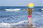 Beach little girl colorful ball vacation playing in blue sea