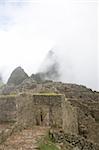 Machu Picchu is a pre-Columbian Inca site located 2,430 metres (8,000 ft) above sea level. It is situated on a mountain ridge above the Urubamba Valley in Peru, which is 80 kilometres (50 mi) northwest of Cusco and through which the Urubamba River flows. The river is a partially navigable headwater of the Amazon River. Often referred to as "The Lost City of the Incas", Machu Picchu is one of the m